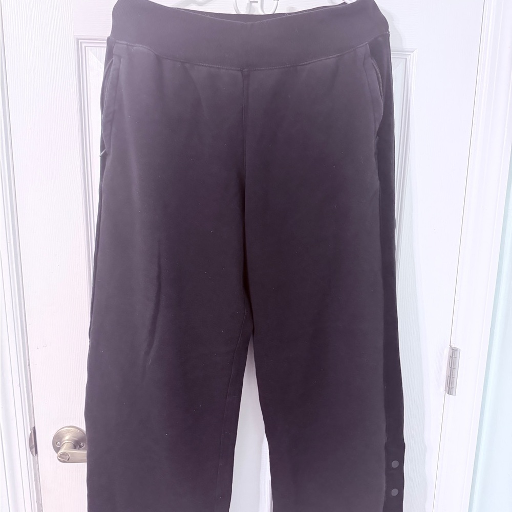 Black Athleta wide leg sweatpants with velvet trim and buttons